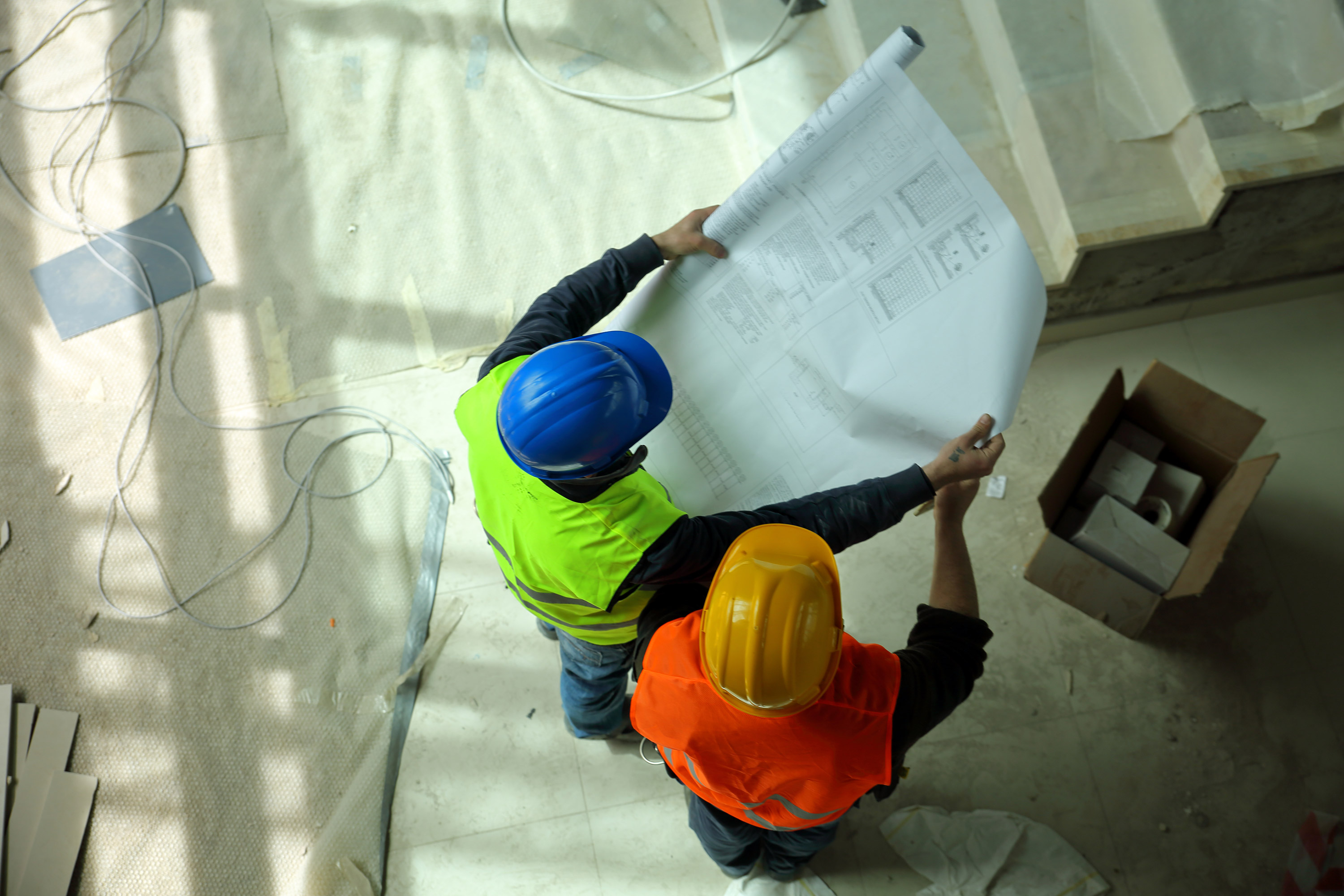 Construction-workers-reading-blueprints