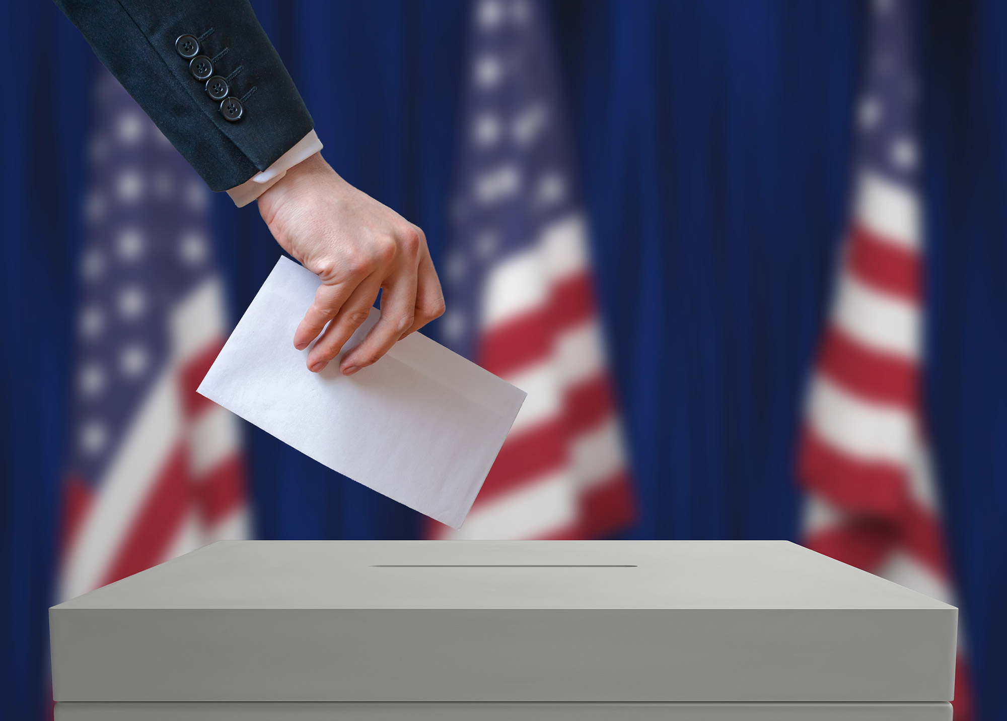 Voter-holds-envelope-in-hand-above-vote-ballot