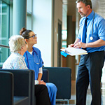Doctor-talking-to-a-patient-in-hospital-corridor_thumbnail